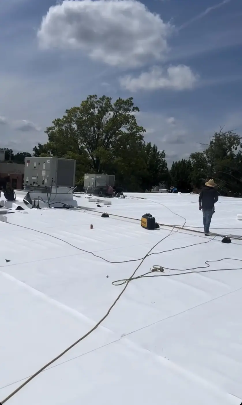 Crew welding TPO seams on a commercial roof