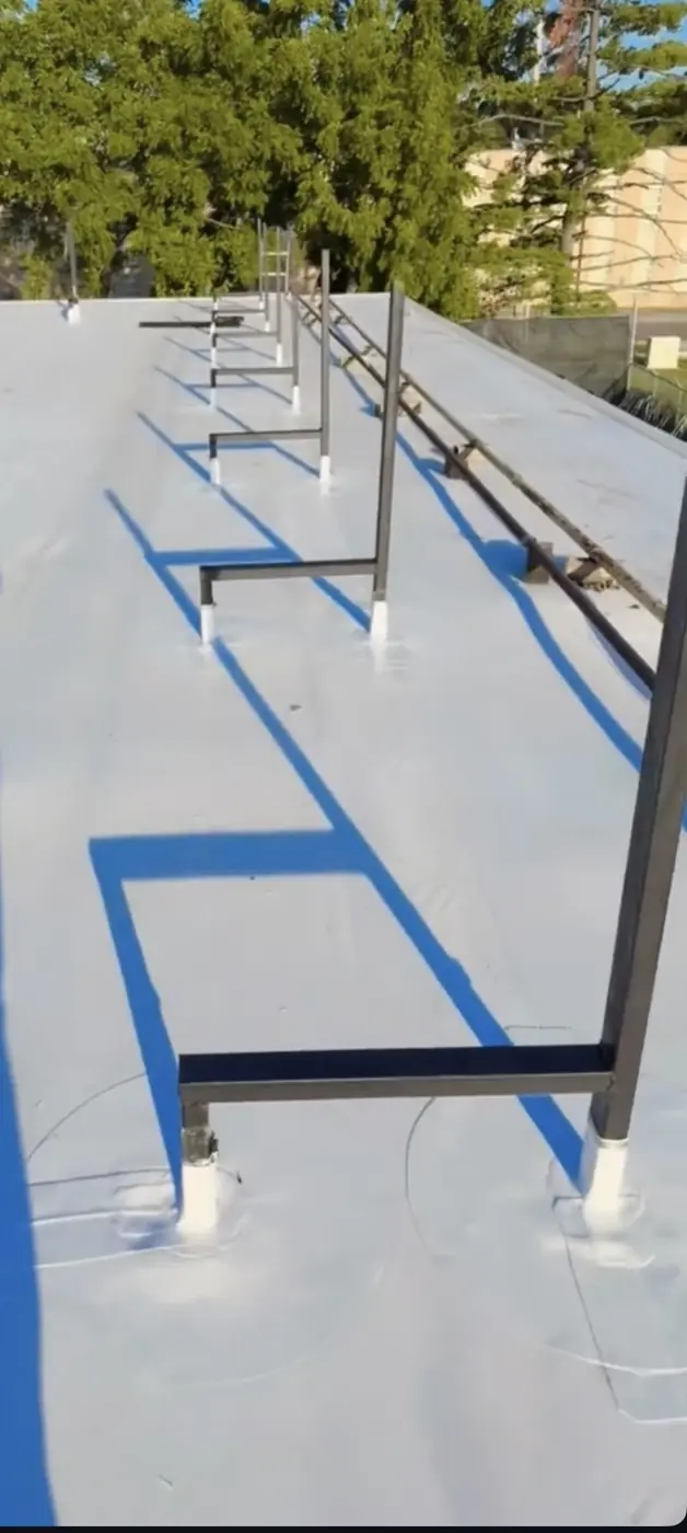 Finished TPO roof with rooftop pipe supports