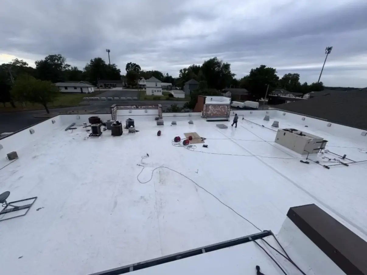 Commercial TPO roof with rooftop units and penetrations